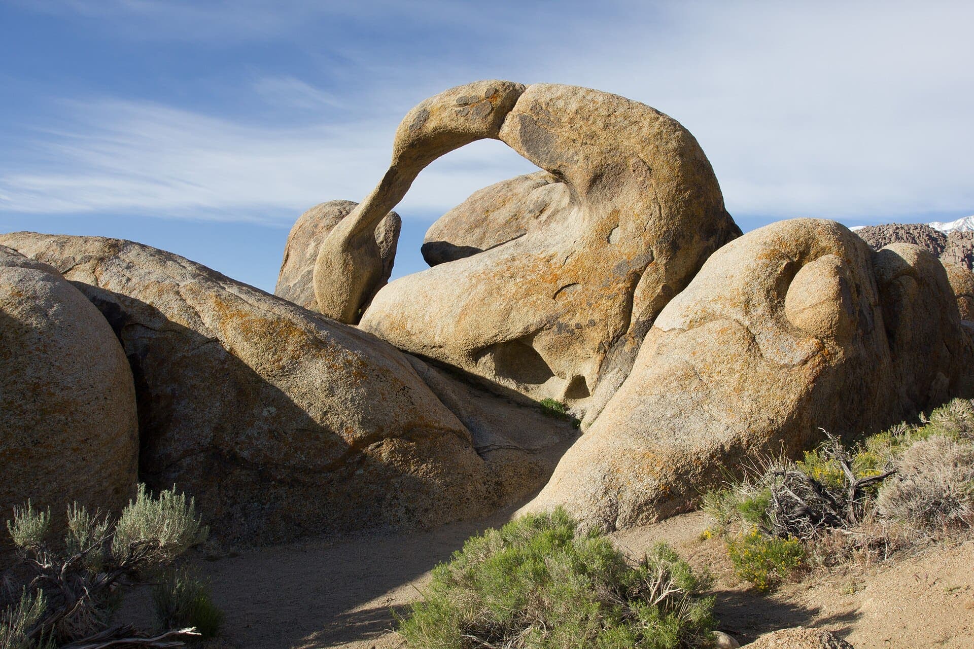 Mobius Arch framing the snow-covered Sierra crest at dawn